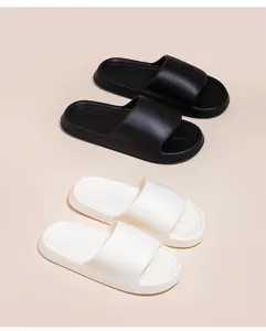 Detailed view of lightweight EVA cushion slides showcased in classic black and white colors.