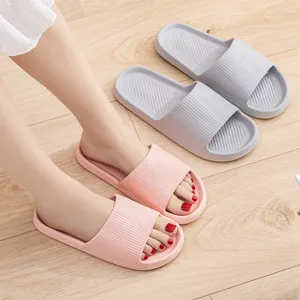 Comfortable non-slip home slippers for couples, soft EVA shower sandals in pink and grey.