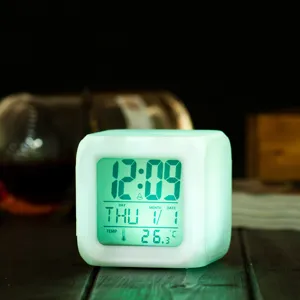 Close-up view of the glowing LED digital alarm clock showing clear time and temperature details.