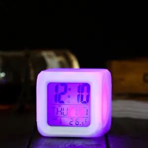 LED color-changing digital alarm cube clock with night light and temperature display detail.