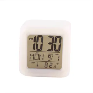 Square digital LED alarm clock with color-changing night light and temperature display.