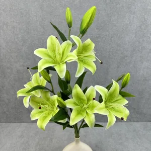 Artificial lily flower detail showing realistic petals and green leaves for home decor.