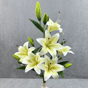Close-up detail of 6-head artificial lily flowers featuring realistic yellow petals and green buds.