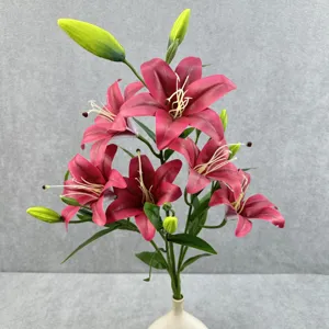 Close-up detail of 6-head artificial lily bouquet with vibrant dark pink petals and green leaves.