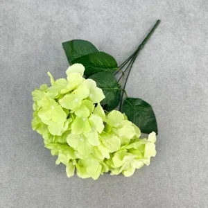 Close-up detail of artificial green hydrangea flower branch, perfect for floral arrangement decor.