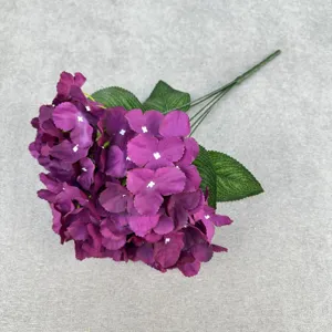 Closeup view of purple artificial hydrangea flower branch showing detailed petals and stem.
