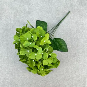 Detailed close-up shot of artificial green hydrangea branch with realistic petals and stem.