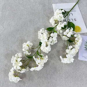 Artificial white pearl flower branch detail, realistic fake floral for home decor photography.
