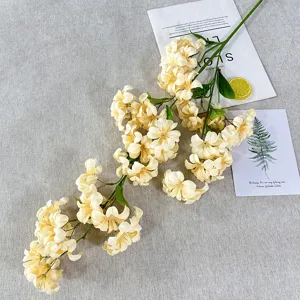 Artificial cream flower branch for home decor, delicate simulation plant detail view.