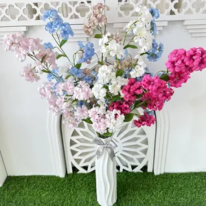 Artificial flower bouquet arrangement with white ceramic vase for home decor and photography.