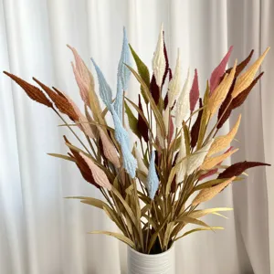 Detailed view of colorful artificial flocked reed bouquet in white vase for home decor