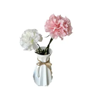 Artificial carnations flowers in white ceramic vase home decor for wedding and party