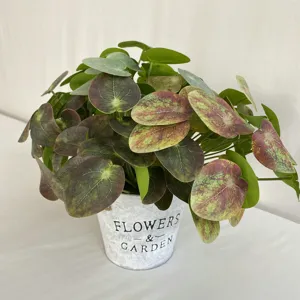 Artificial potted plant with 3D marbled leaves in metal bucket for home decor.