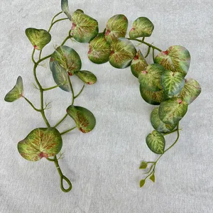 Detail view of artificial vine leaf texture, realistic green foliage for wall decor.