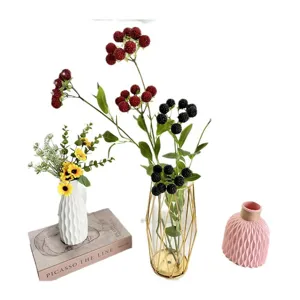 Artificial berry branches and decorative ceramic vases set, modern home living room decor style.