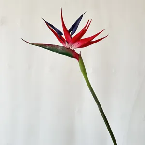 Artificial bird of paradise flower detail, silk floral decor for home restaurant photography.