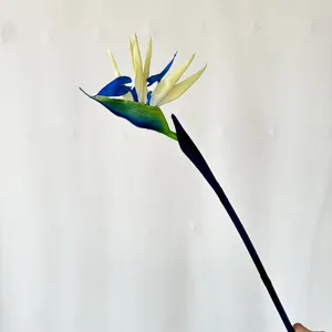 Artificial bird of paradise flower detail shot, blue and white stem decor for home and photo.