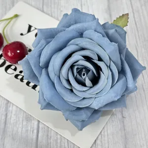 Detailed view of a blue artificial rose flower head with lush petals for DIY crafts and decor.