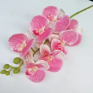 Detailed view of artificial pink Phalaenopsis orchid flower, realistic floral decor piece.
