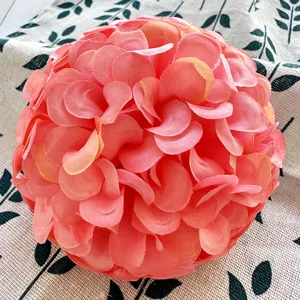 Close-up of handmade artificial hibiscus flower ball with soft pink silk petals for wedding decor.