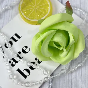 Light green artificial rose flower head detail for wedding party and event decoration.