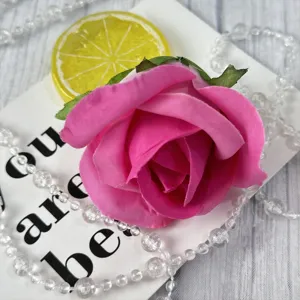 Detailed closeup of pink artificial rose flower head, perfect for wedding and event decor.