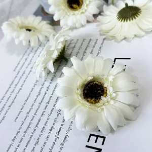 Close-up detail of white artificial daisy flower heads, perfect for table decor and props.