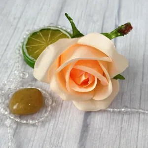 Close-up view of artificial peach rose flower head detail for decorative crafting projects.