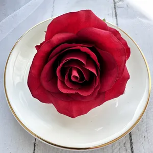 Close-up detail of dark red artificial rose flower head, perfect for DIY crafts and decor.