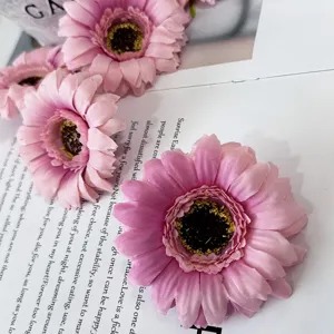 Artificial pink gerbera daisy flowers for home table decoration and photography props.