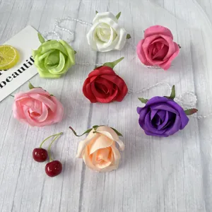 Colorful artificial rose flower heads for wedding and party decorations, fabric floral decor.
