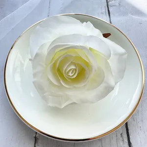 Close up of white artificial rose flower head for wedding table decor and DIY craft.