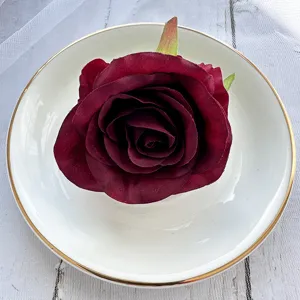 Burgundy artificial rose flower head detail shot for DIY crafts, wedding decor and corsage design.