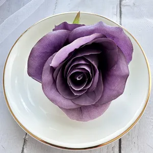 Artificial purple rose flower head, elegant table decoration and DIY craft accessory.