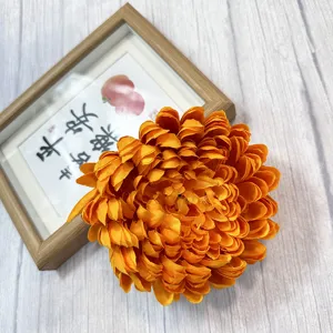 Orange artificial chrysanthemum flower head for home hotel showcase display decor.