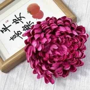 Close-up detail view of vibrant magenta artificial chrysanthemum flower head for home decor.