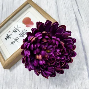 Detailed close-up of a dark purple artificial chrysanthemum flower head for decor.
