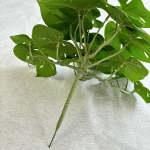 Artificial monstera leaf plant stem detail view, perfect for home decor and indoor greenery.