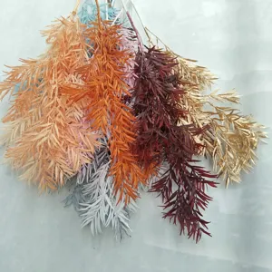 Detailed shot of colorful artificial pine branches, perfect for wedding floral arrangements.