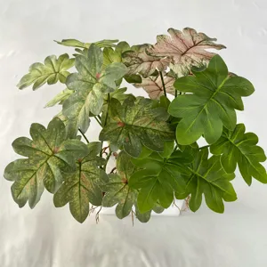 Artificial plant detail shot featuring vibrant green and variegated pink leaves for home decor.