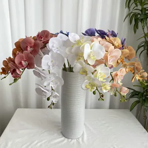 Detailed view of 3D French artificial Phalaenopsis orchid flowers in a white ceramic vase.