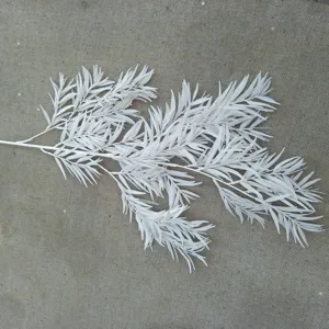 Detail view of white plastic artificial pine branch, perfect for wedding floral arrangement.