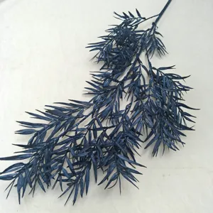 Artificial blue pine branch detail, dense foliage for floral arrangement and wedding decor.