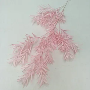 Artificial pink pine branch detail, frosted plastic foliage for wedding floral arrangement.