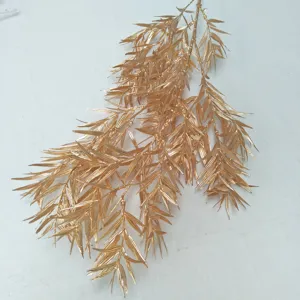 Gold artificial bamboo leaves plastic frosted branch wedding floral arrangement decor.