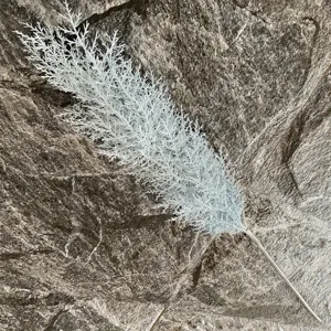 Close-up of white artificial pine branch for modern home decoration and floral design.