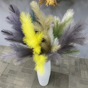 Detailed view of colorful artificial pampas grass arrangement in a white vase for home decor.