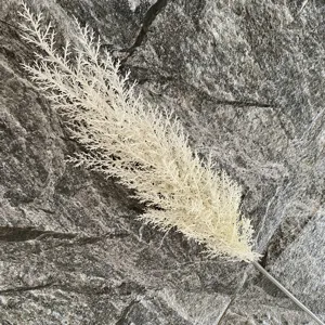 White artificial reed flower branch plastic fake plant for home decor detail shot