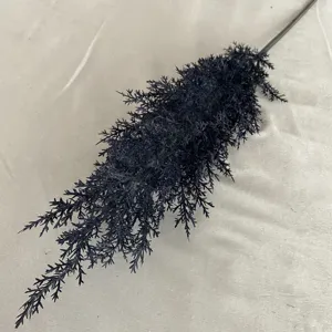 Detailed view of single black artificial plant branch, plastic greenery stem for home decor.
