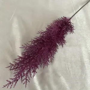 Purple artificial pine needle branch fake plant flower detail for home room interior decor.